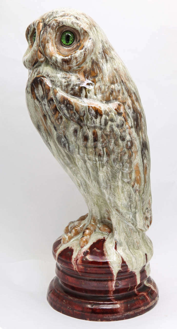 A rare signed Emile Galle  faience owl with mottled glazes on a round base, glass eyes, signed Emile Galle Nancy