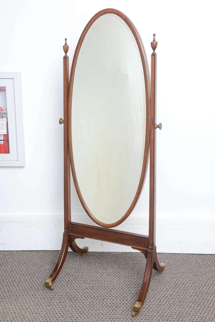 This is a very nice mahogany Cheval mirror on stand made in England.
It sits on Edwardian style legs and has the original brass castors as well as the turning brass knobs which hold the mirror in place.
The mirror is a little frosted but looks