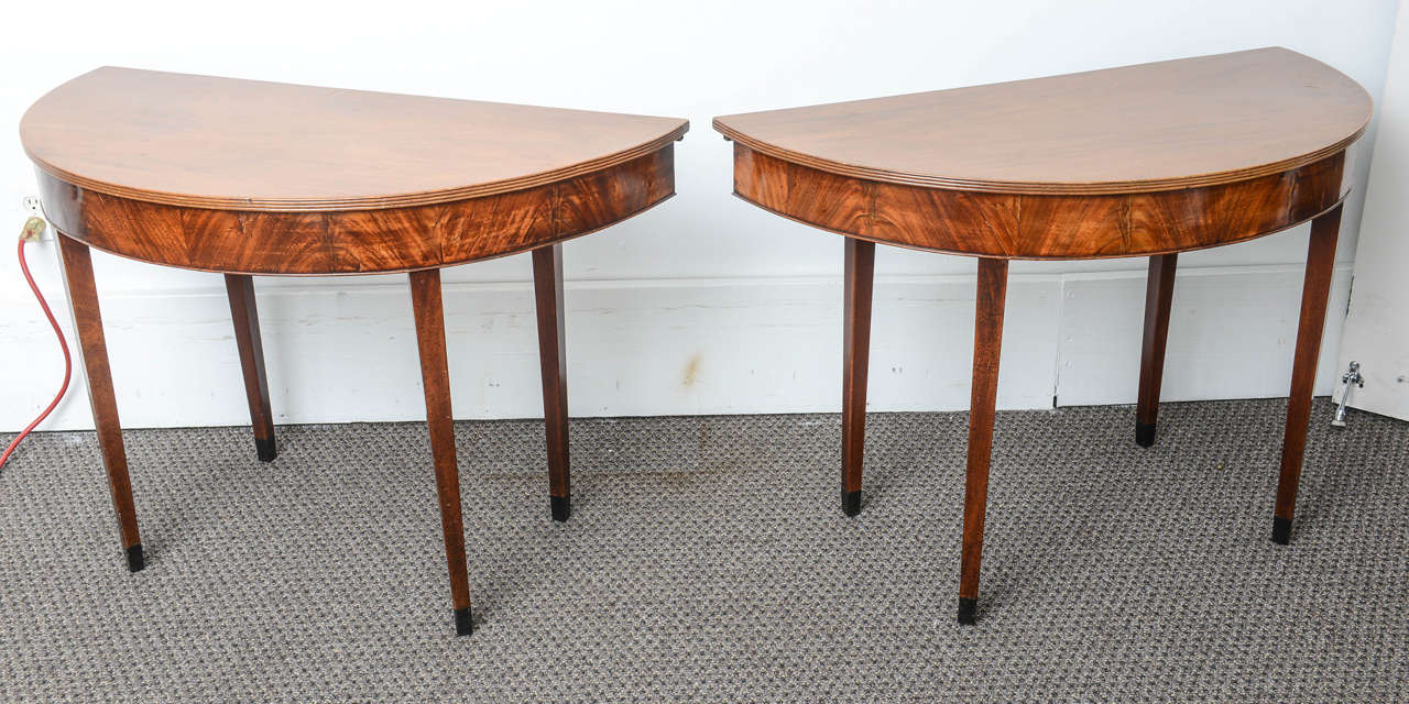 This is a very nice solid mahogany dining table made in England circa 1870.
It has 2 D end Console tables to either end and a drop leaf table to the center, there is also an extra leaf been made so it will seat about 10 people.
It sits on square