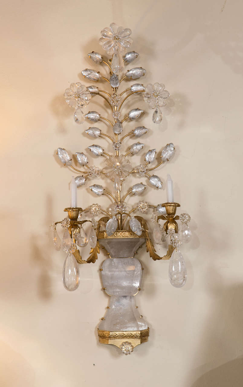 A Fine Pair of Maison Bagues Style Bronze and Rock Crystal Sconces. The bronze bracket bottom base holding up a rock crystal flower vase having rock crystal roses, vines and leafs flowing from the vase. Two candle holder arms with crystal drops
