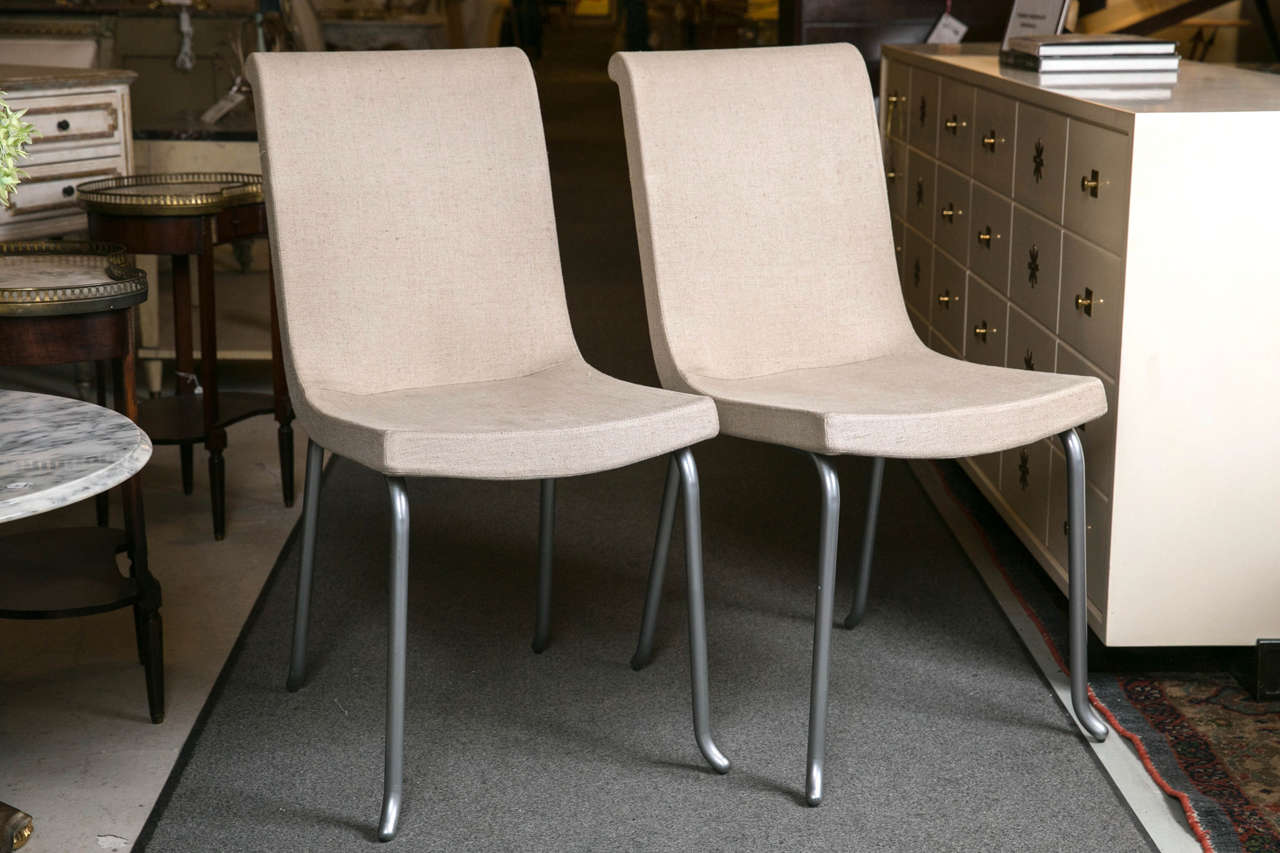 Set of six Roche Bobois chairs. Contemporary dining chairs with grey linen fabric. Steel legs and structure. This very sleek design would look wonderful in any modern or Mid-Century Modern setting. Purchased directly from the current owner who