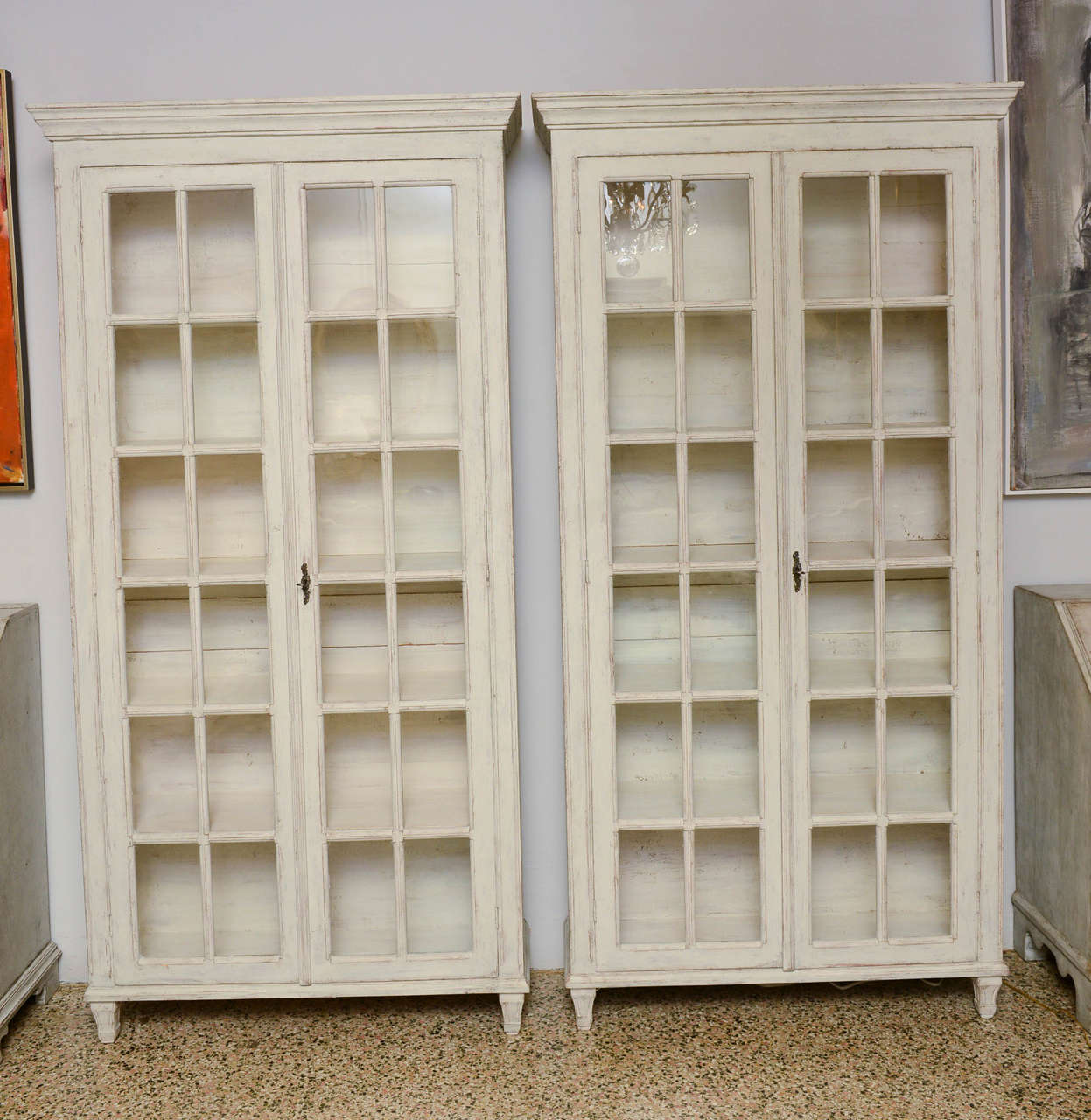 19th Century Pair of unusually large Swedish Antique Period Gustavian Book Cabinets with five shelves and original glass doors, locks and hinges; each glass panel is framed and simple but elegant square medallion is carved at each centre junction of