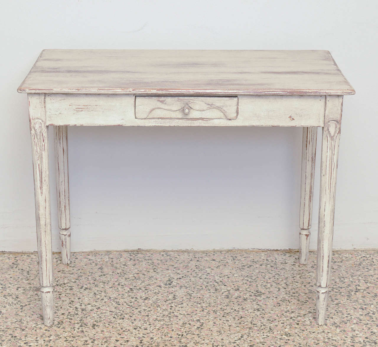 Early 19th Century Antique Swedish Gustavian Table in washed greyish green colour with three drawers, each drawer has a raised wingspan design carving and an original carved pull; there is a centre drawer at front and a drawer on each side of the