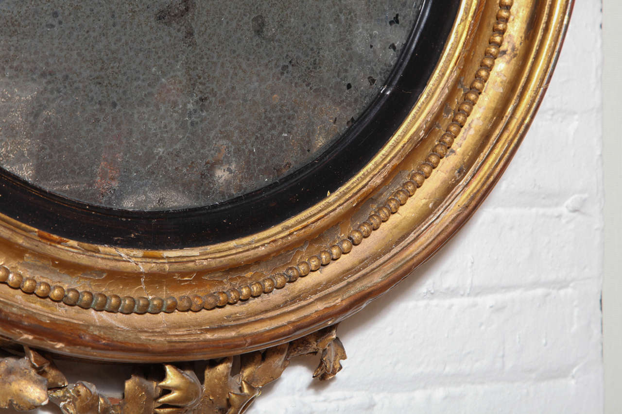 A Carved, Gilded and Ebonized Bullseye Mirror, England c. 1850 In Excellent Condition For Sale In New York, NY