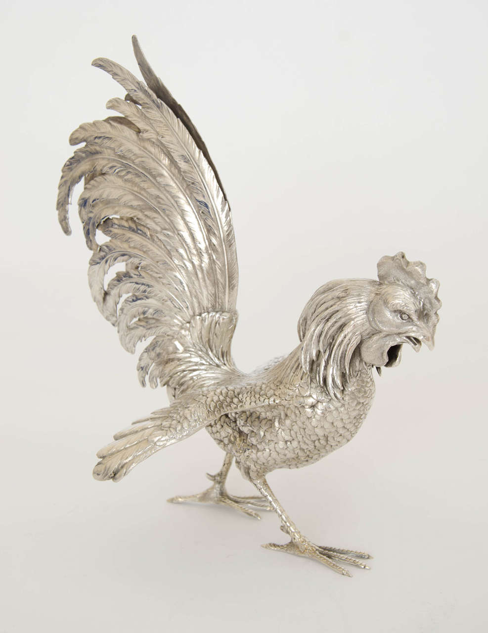 A lovely pair of German Silver 800 standard fighting cocks made c 1910 by Jean L  Schlingloff of Hanau. The birds are realistic fighting poses and will make a wonderful conversation piece on any dining table or displayed anywhere. Height of one bird