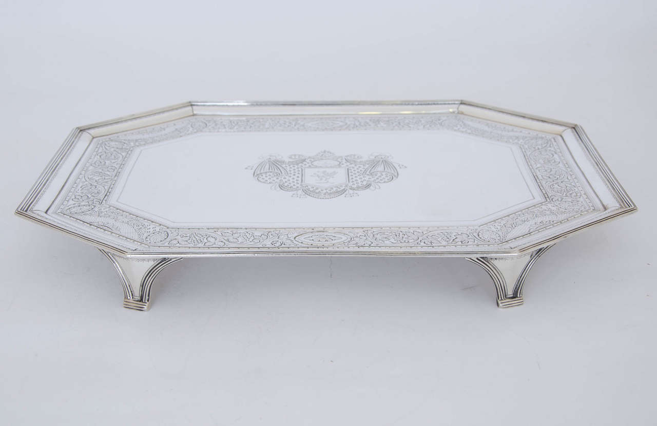 Antique Silver George III Salver made by John Hutson of London in 1786. The Salver is of rectangular form and stands on four shaped moulded feet. It is beautifully engraved with a border of leaves and grapes and cartouches containing flowers. The