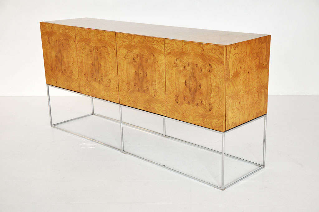 Burl wood credenza on chrome base.  Designed by Milo Baughman for Thayer-Coggin.  Beautiful wood pattern across cabinet front.