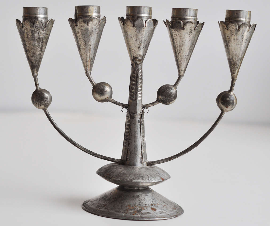 A pair of tin candelabra by William Spratling with stylized leaf motif and impressed design.  Both signed on base.  As noted in Mexican Silver by Penny Morrill and Carole Berk, Spratling tinware is 