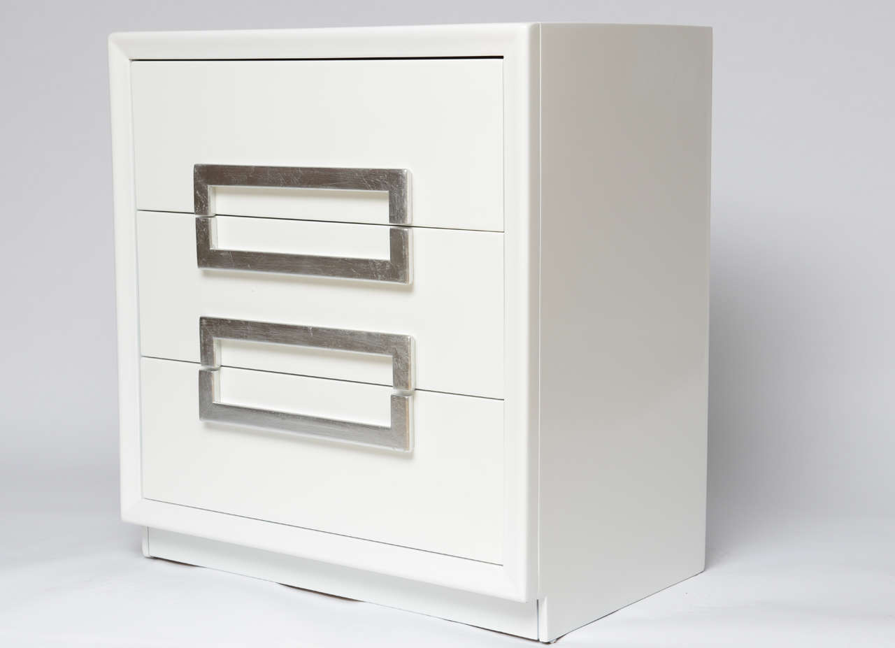 Pair of lacquered vintage Kittinger cabinets. High gloss white lacquer with silver-leaf handles. Three drawers.