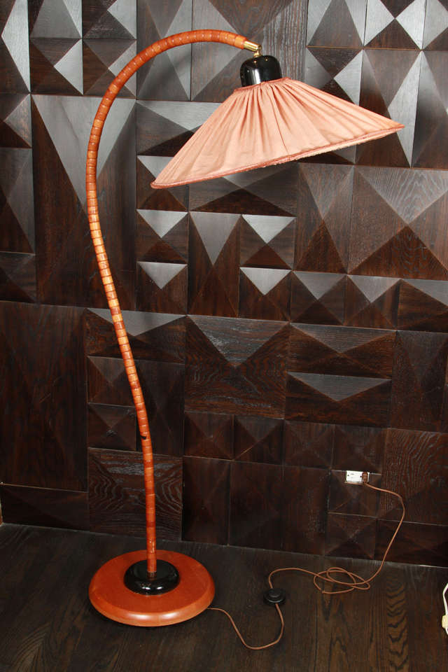 Art-deco style floor lamp. Articulated silk shade, ribbed beech curved frame, beech base with blackened wood. Denmark. 