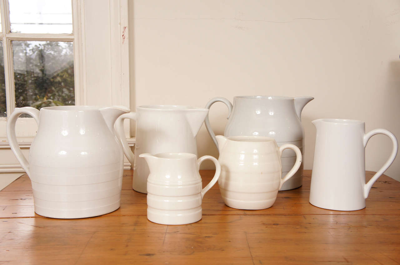 This collection of antique milk jugs comes in various heights, diameter and shapes. All are circa 1890 and some with Ribbed sides. They look wonderful in the spring and summer with water and fresh flowers. Feel free to use them for serving, as well.