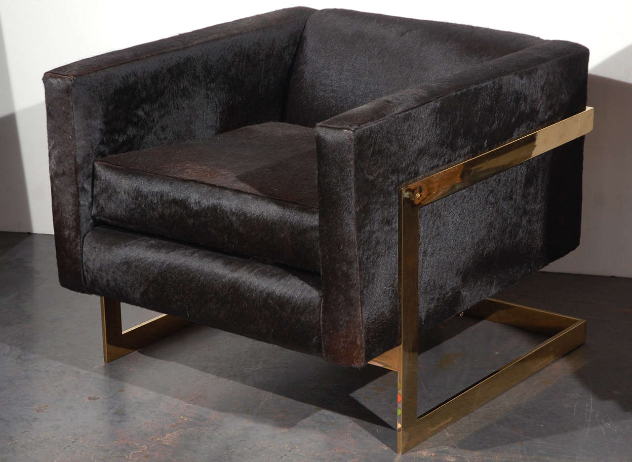 A vintage pair of brass and black pony hair armchairs attributed to MIlo Baughman. Heavy flat brass construction on the metal frame. Newly reupholstered in shimmery black pony hair. 

Also see separate listing for matching sofa.