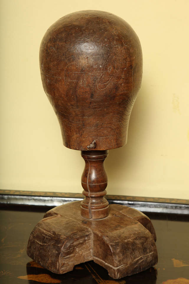 Very Fine French 18th Century Solid Walnut Perruque (Wig Stand) with wonderful color and patination, the softly formed head on a turned baluster standard supported on a cruciform block stand.