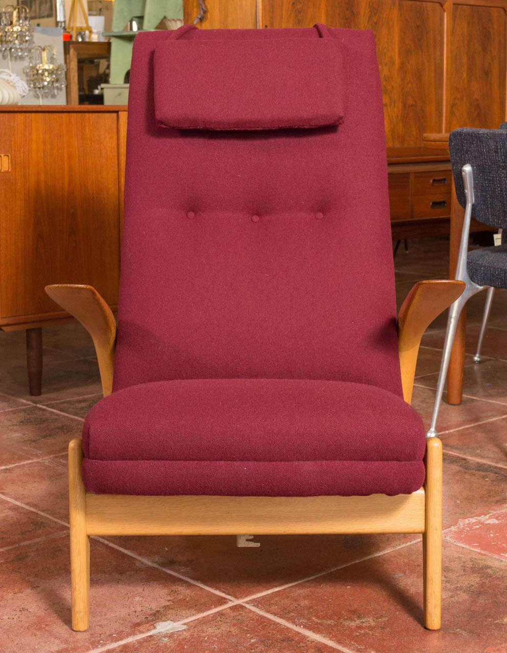 Offering an uncommon and very comfortable high back easy chair by Gimson and Slater LTD. Was designed in Norway and manufactured in England  The chair allows you to rock back and forth or with a handle on the side allows you to lock in the seat at