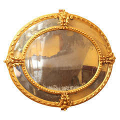 A French Louis XVI Style Oval Mirror with Carved and Giltwood Frame