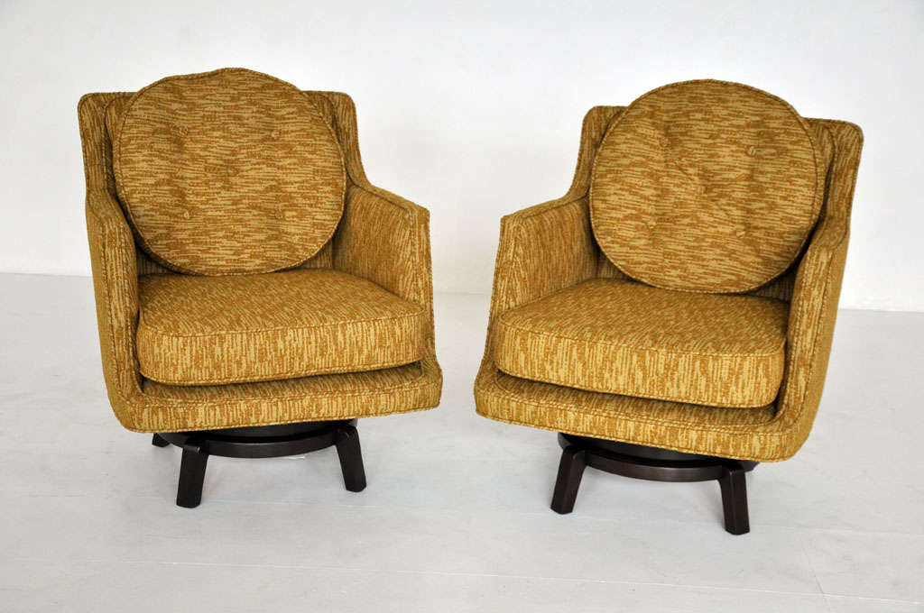 Pair of swivel lounge chairs designed by Edward Wormley for Dunbar. Model #5609. Mahogany bases with newly upholstered seats.
