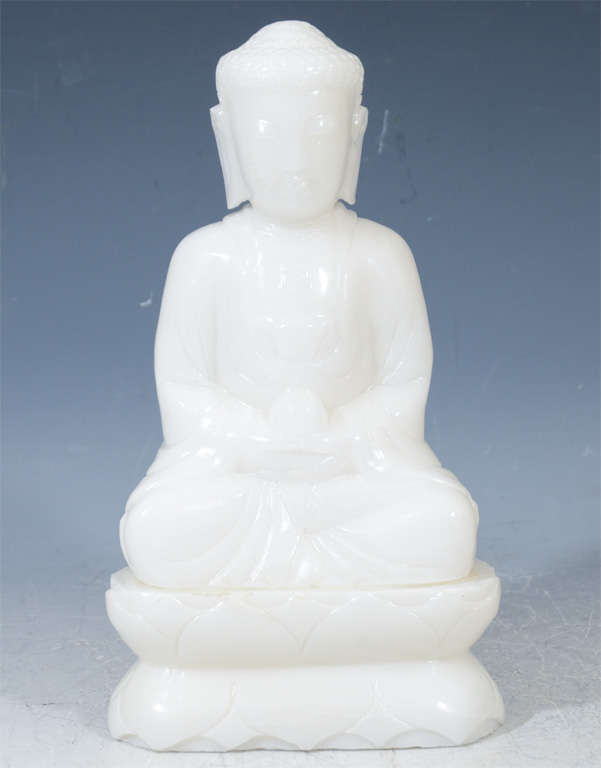 An antique Chinese sculpture of Buddha in white jade dating from the late Ching dynasty (approx. early 20th century). Buddha sits atop a stylized lotus in the classic Dhyana mudra of meditation.
