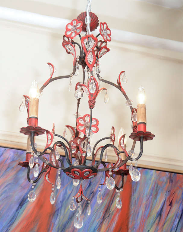 A vintage chandelier composed of a black and red enameled metal body with clear glass faceted bead accents and floral detailing.

4824