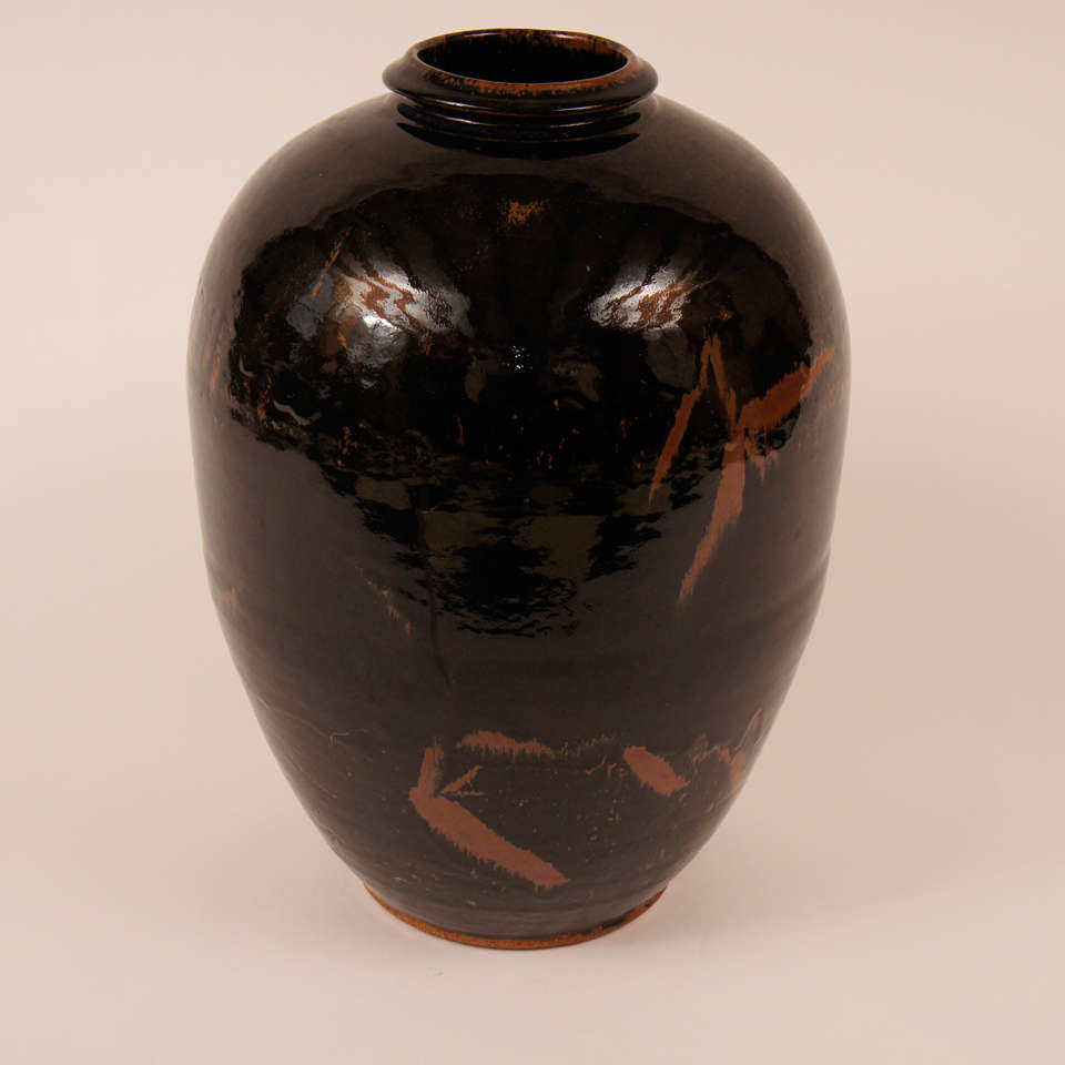 This beautifully decorated and glazed floor vase required an enormous degree of skill to throw. The shape is nearly perfect. The rich black glaze with coppery colored highlights of underglaze iron is in the style of a Cizhou ceramic from Northern