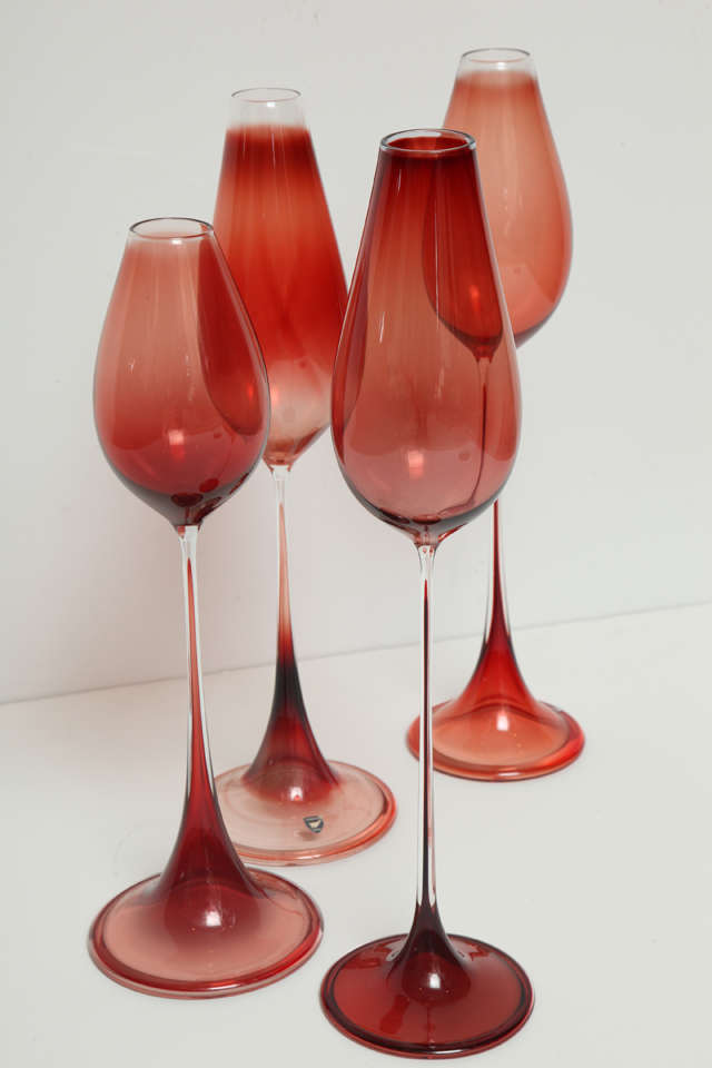 Mid Century glass artist Nils Landberg's Red Tulpanglas designed in 1956, produced in 1957 by Orrefors glassworks. The delicately tinted glasses are blown as a single piece and incised with the designer and maker's marks on the bottom. The