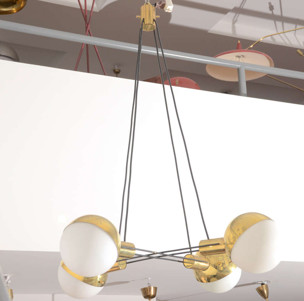 Four Off White Round Globes Connected to Brass Shades