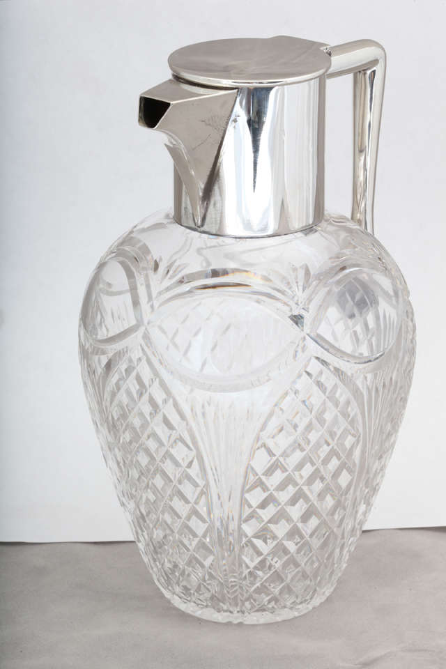 Edwardian, sterling silver-mounted claret jug, Birmingham, England, 1910, J. Grinsell & Sons - makers. Glass is 
