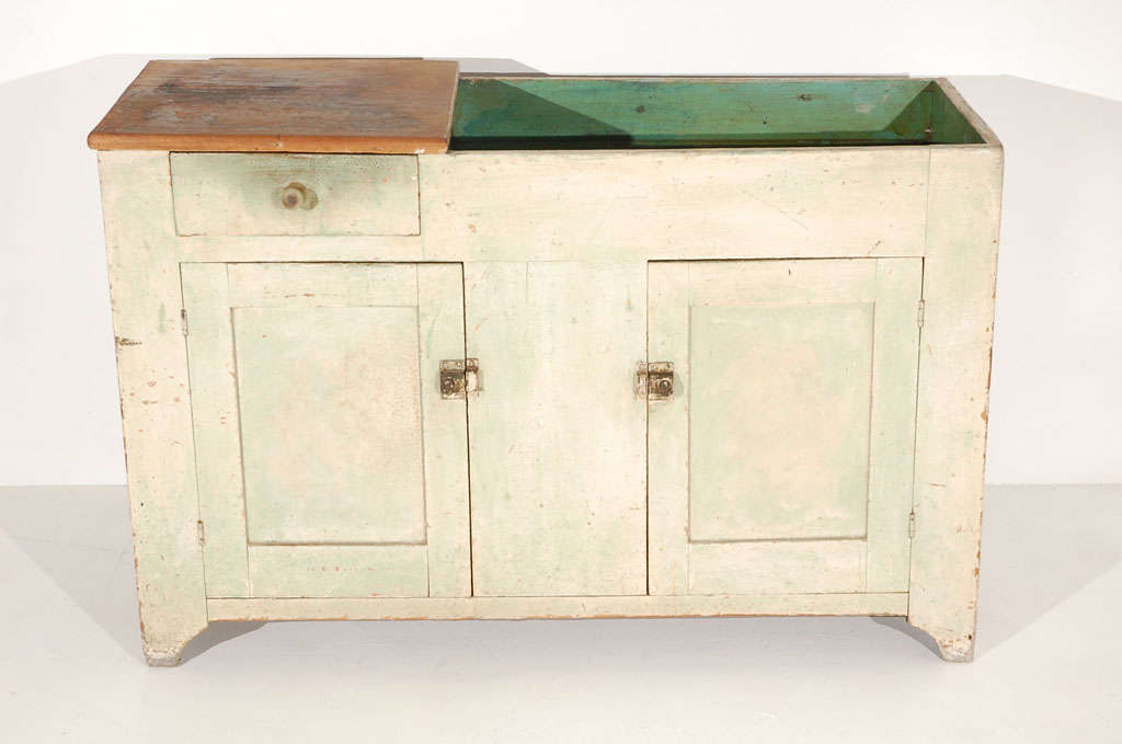 EARLY 19THC ORIGINAL BUTTERMILK PAINTED OVER GREEN TWO DOOR DRY SINK FROM PENNSYLVANIA.THIS WONDERFUL COUNTRY SINK HAS A DRAWER UNDER THE COUNTER SCRUB TOP.THE INSIDE SURFACE OF THE SINK  IS A GREAT SHADE OF BLUE GREEN PAINT.IN SOME ARES OF THE