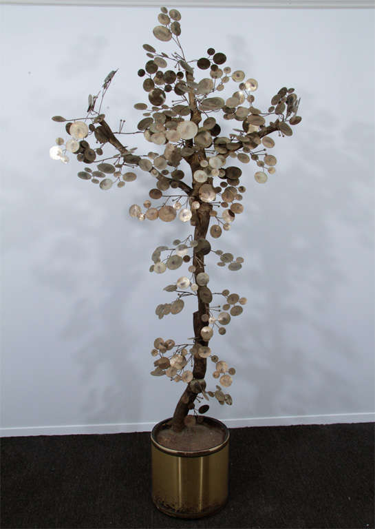 Tree form sculpture made of cut metal circles and brass rods mounted to a gilt wood branch. The branch is anchored in a brass and foam composite pot. Designed by Curtis Jere.<br />
<br />

4078