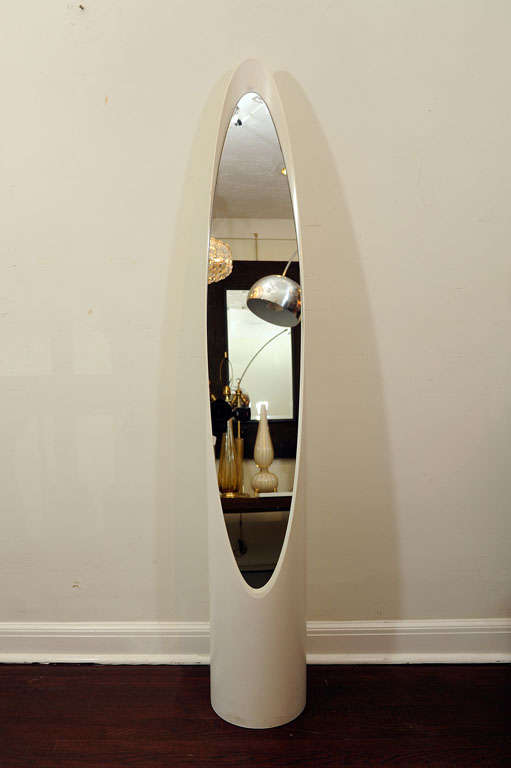 A soft white sleek and sexy mirror designed by Roger Lecal.