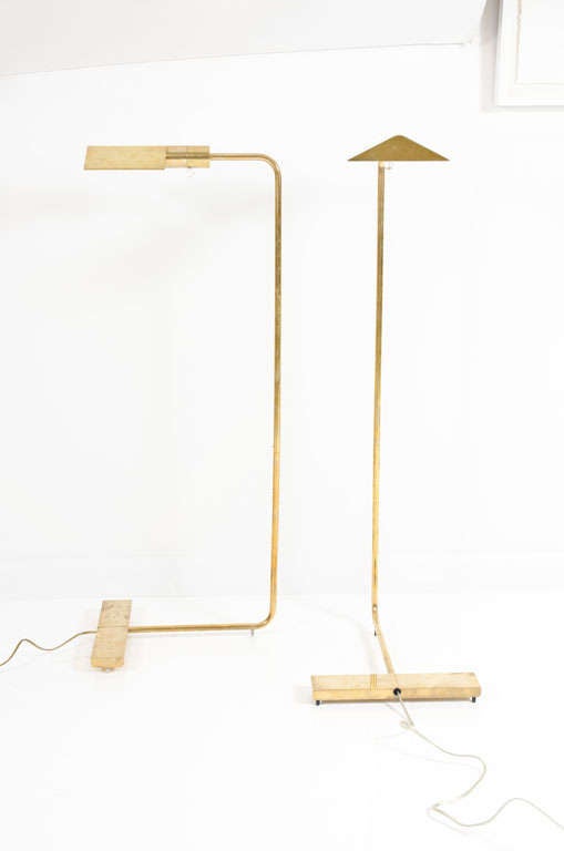 An exquisite pair of reading lamps comprising pyramid shades with brass ball switches that cantilever on swivelling stems with weighted bases all in a polished brass finish. By Cedric Hartman. American, circa 1970.