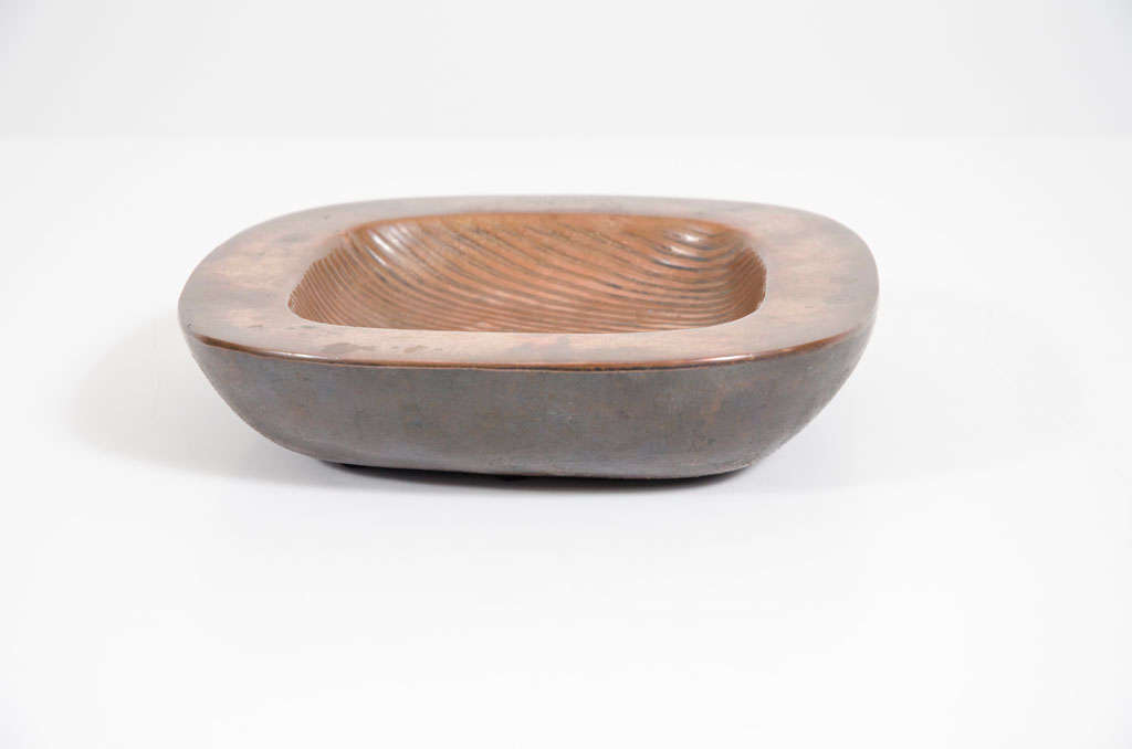 A shallow copper dish in a square form with softened corners and a grooved interior. By Ben Seibel for Jenfredware. U.S.A., circa 1950.