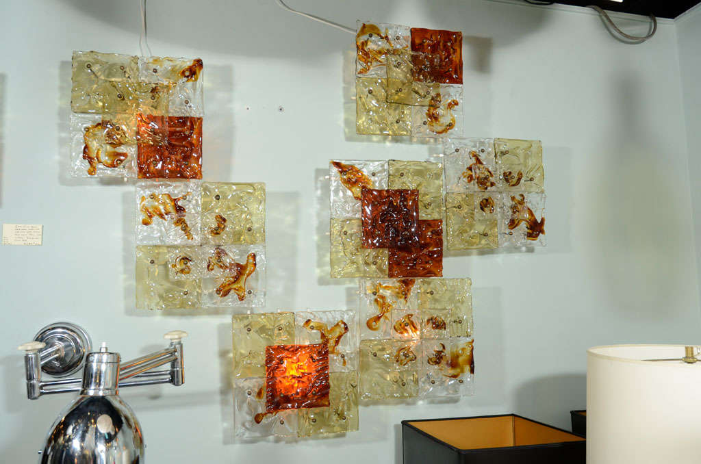 Two pair available of these documented Venini clear, amber and gold glass square sconces. Each consists of four 6
