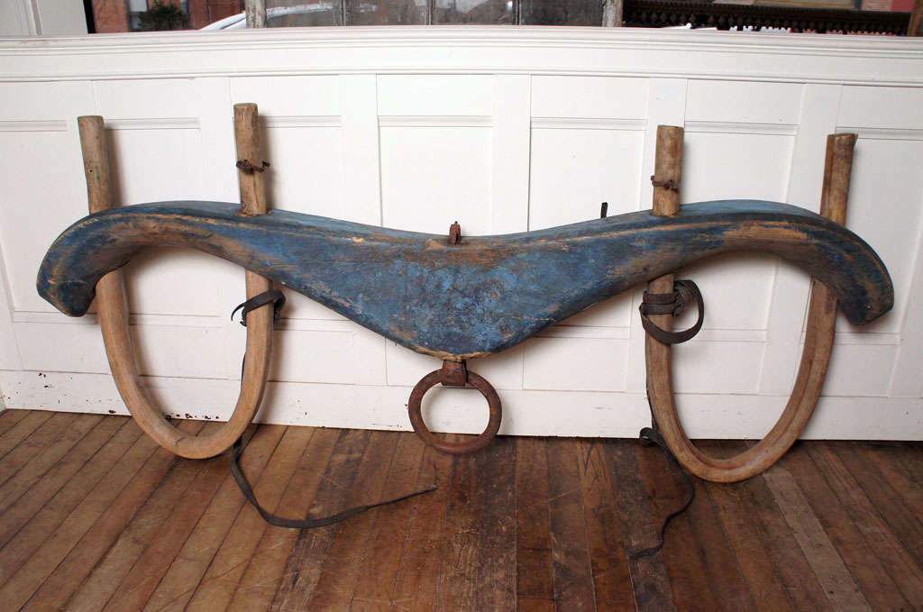 large oxen yoke in untouched blue painted oxidized surface - 
carved out of one piece of wood - 
bent hickory yokes - 
hand wrought iron attachments - 
remnants of leather strapping