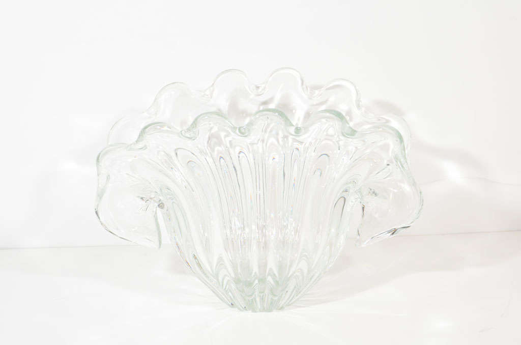 Elegant hand blown bowl or vase<br />
with stylized sea or mollusk shell<br />
design. Vase has winged sides<br />
as well as fluted detailing.<br />
Makes a wonderful centerpiece<br />
or decorative object for a <br />
console or dining table.