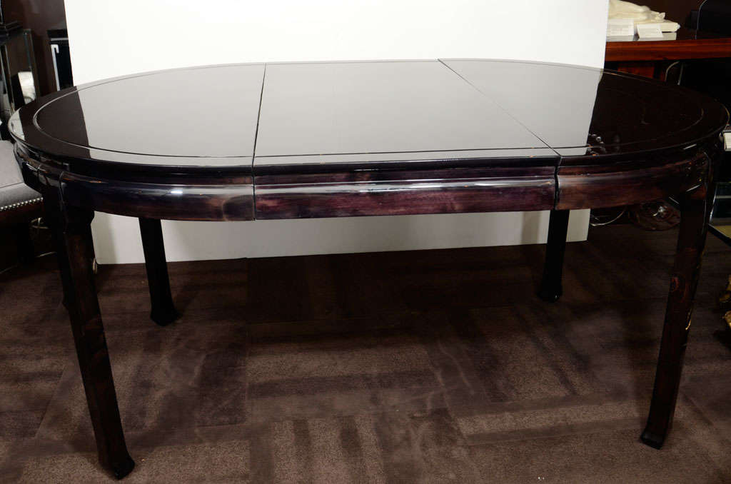 Mid-Century modern dining table in ebonized mahogany. It includes a 20 inch leaf which fits into the center. Mint restored condition.