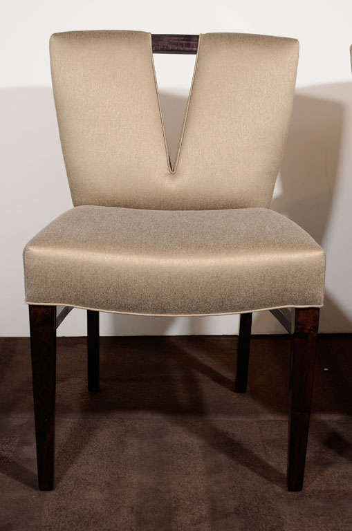 Set of six elegant dining chairs with <br />
plunging neckline center design.<br />
Set includes two host chairs and <br />
four side chairs,  in mahogany<br />
and newly upholstered in a<br />
metallic mushroom/taupe<br />
colored sharkskin