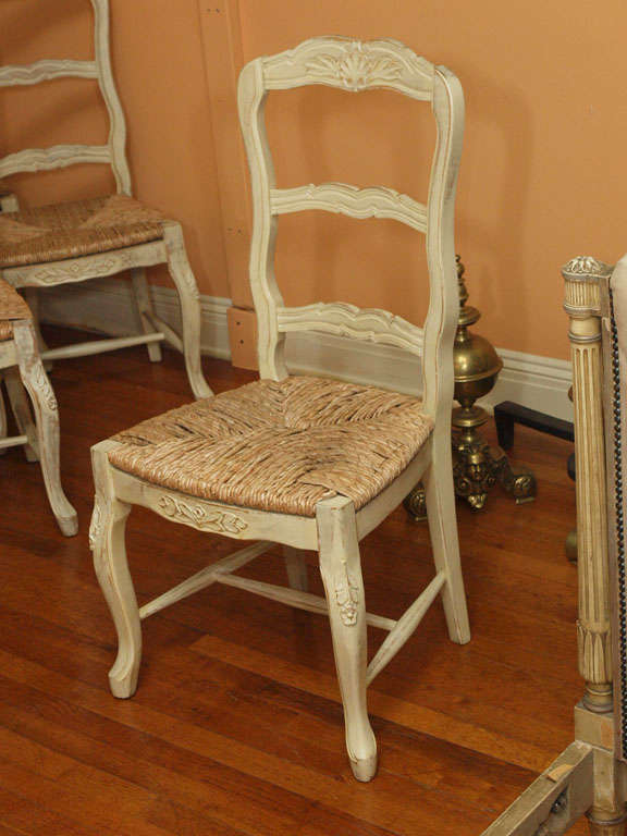 Set of eight French provincial painted rush seat chairs. at 1stDibs