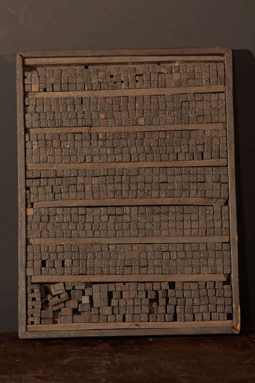 Chinese woodblock printing set. Used for movable type printing presses, the rectangular wood tray fitted with hundreds of tiny wood blocks, individually carved with Chinese characters, or logograms.