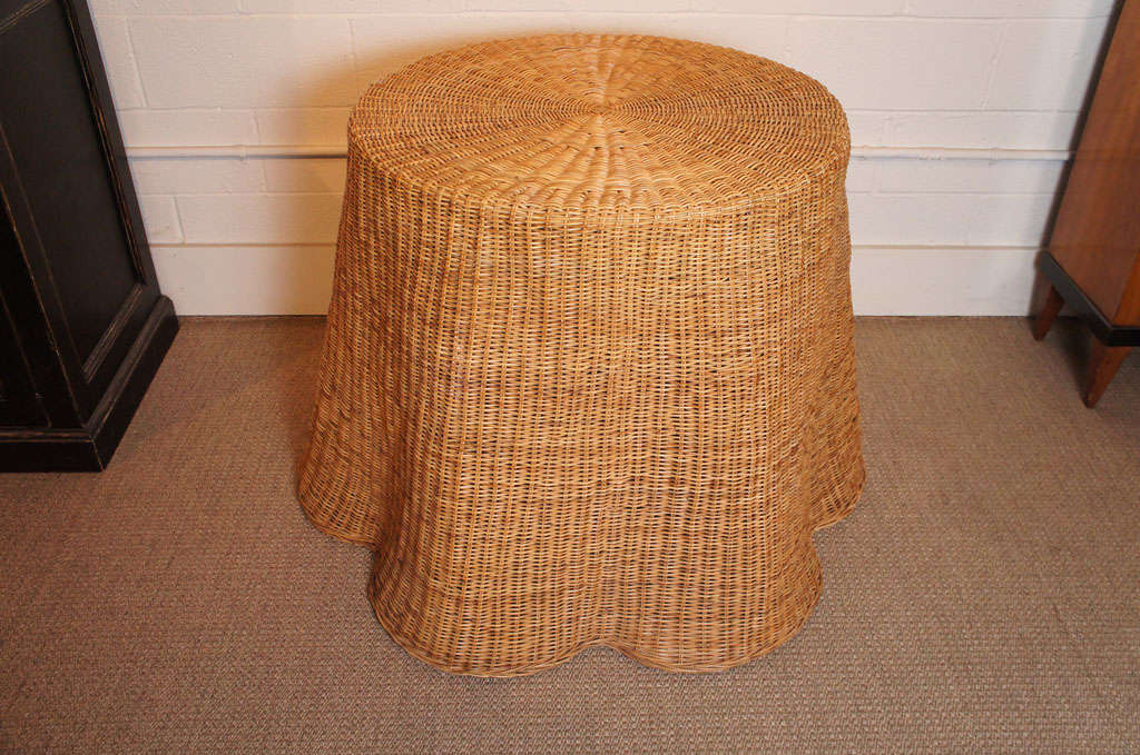 Here is a great pair of draped wicker tables with a fluid curved base.