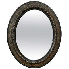 Oval brass inlaid ebonized mirror