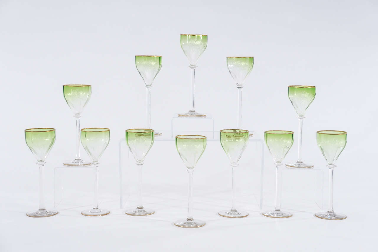 Not your typical wine goblets, these are a dramatic and unusual pattern of handblown crystal goblets by Moser. The subtle apple green shaded to clear, highlights the elegant Art Nouveau intaglio cut floral decoration. The tall, elegant panel cut