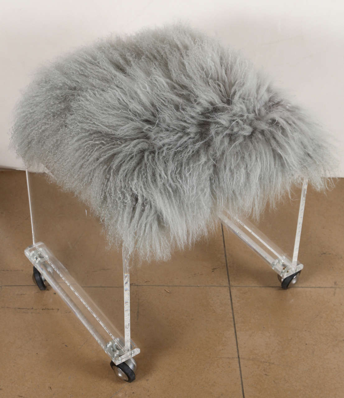Lucite foot stool on waterfall acrylic base with faux lamb wool.