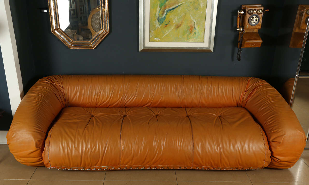 Anfibio Bed by Alessandro Becchi for Giovannetti upholstered in original cognac leather. Couch folds out into a sofa bed with sheepskin mattress.