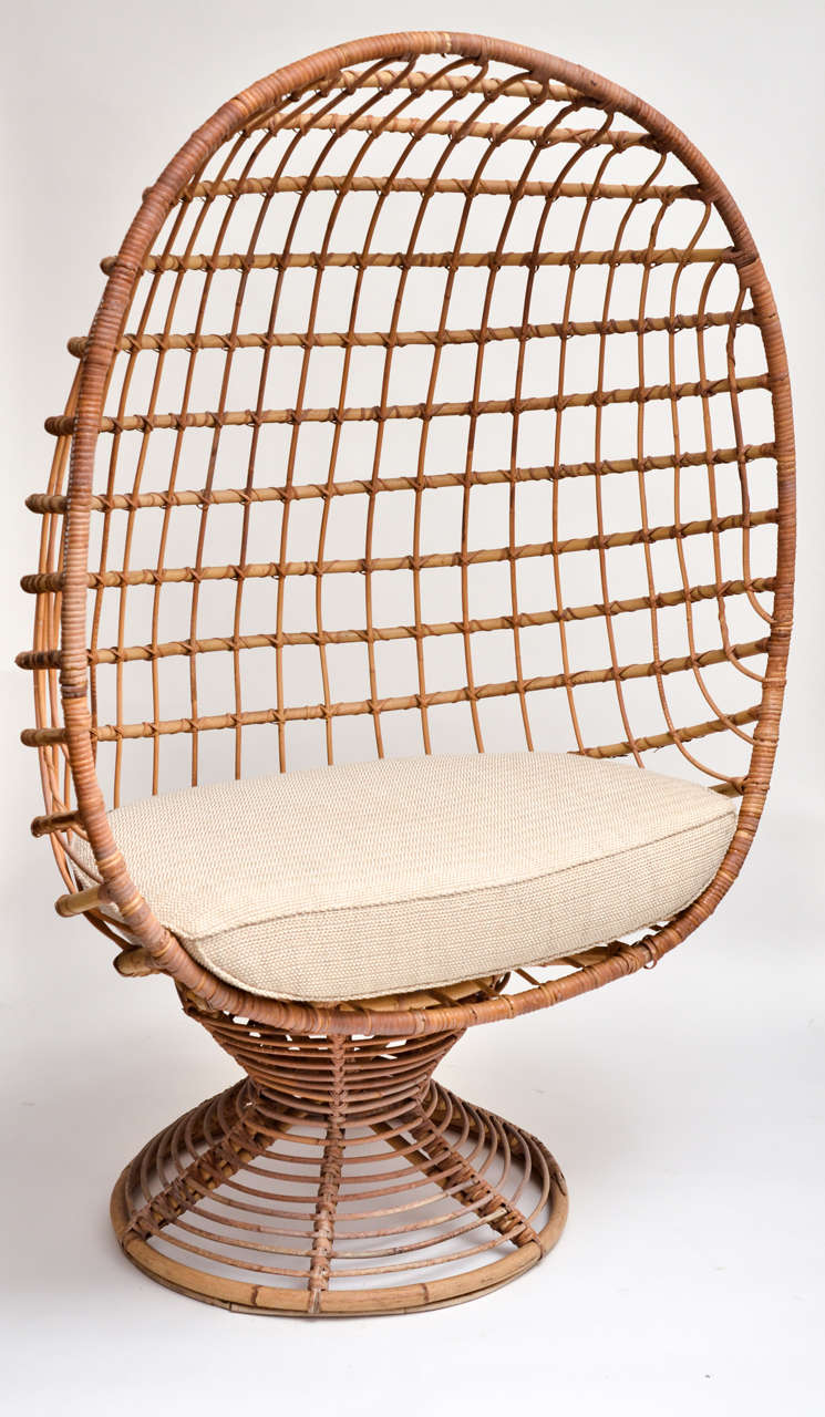Enclosed woven bamboo canopy chair with upholstered seat cushion.