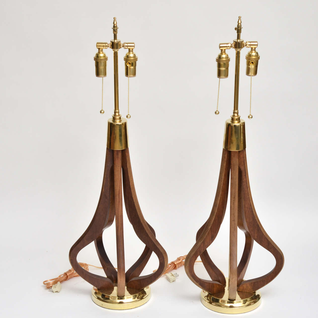 Pair of open bulb form wood table lamps with brass detailing.