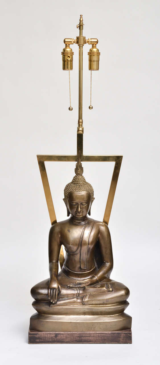 Pair of sculptured bronze Buddhist Asian motif table lamps.