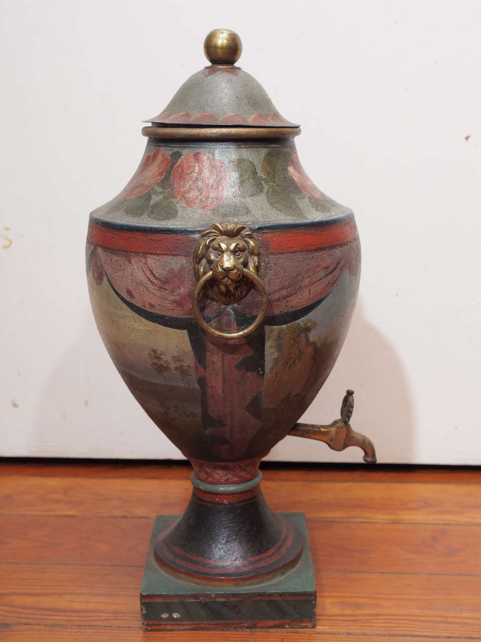18th century painted tole lidded hot water urn with brass spigot and ringed lion handles.