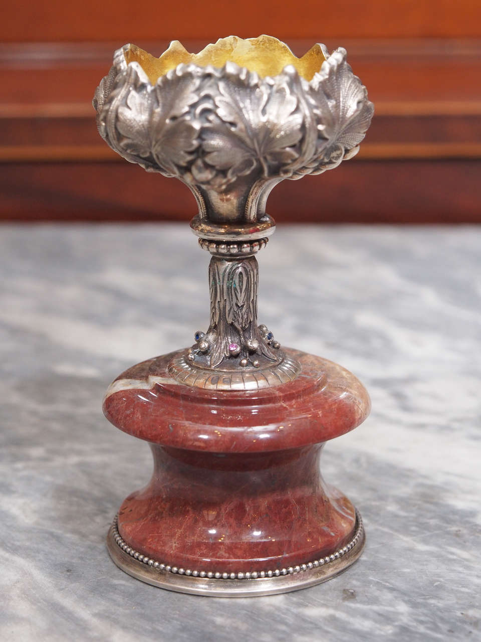 Russian silver and marble vase having figural leaves and berries with foliate design. Mounted on a red marble base. Gold wash interior to silver. Holds 88 silver purity and town marks with Andrei Andreev Aleksandrov Workmaster marks.