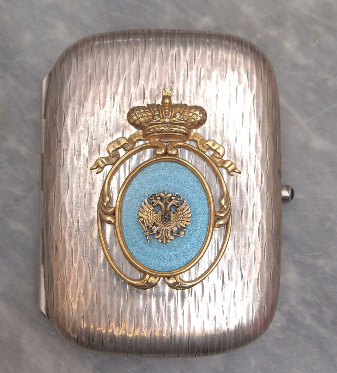 Case with blue guilloche enamel appliqué crowned crew with double headed eagle. Holds 88 silver purity, town and work master marks.