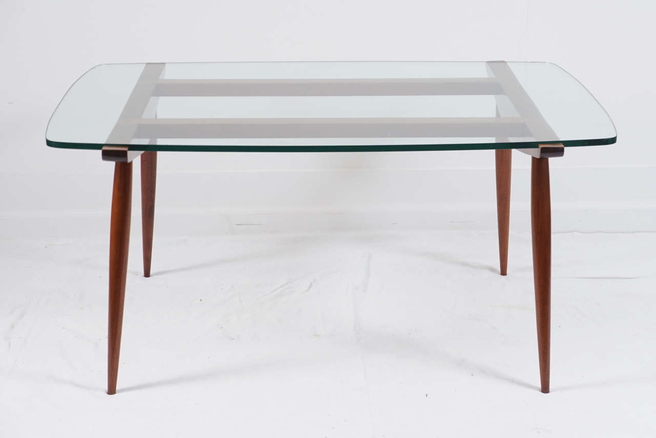a wonderful cocktail table in the style of Ico Parisi.
it could be an original Parisi design?
this table is a truly unique design.
the glass slips right into the top frame to keep it from moving.
the tapered legs add that elegant touch.
sits